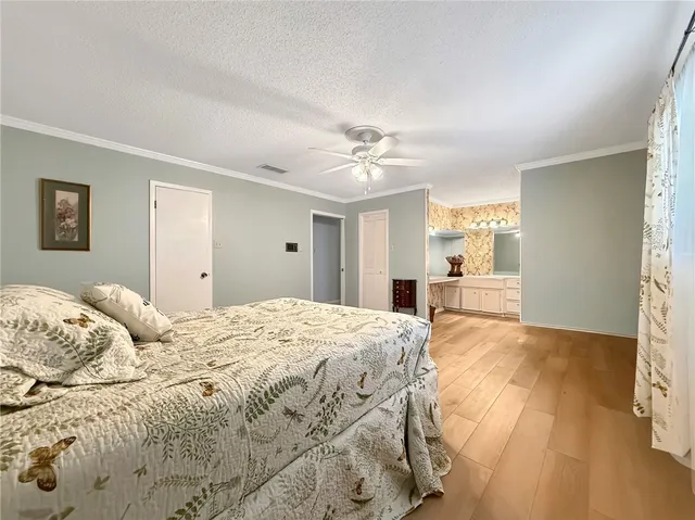 a spacious bedroom with a bed and a view of bathroom