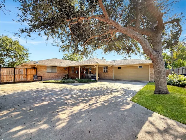 a front view of house with yard space and trees around
