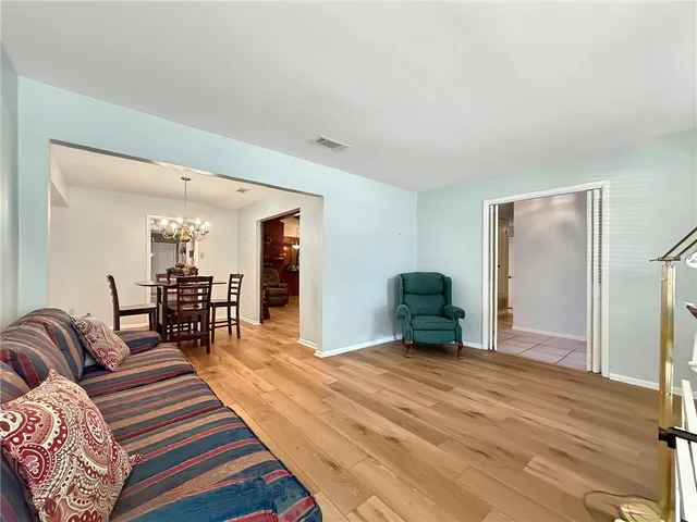a bedroom with furniture and a wooden floor