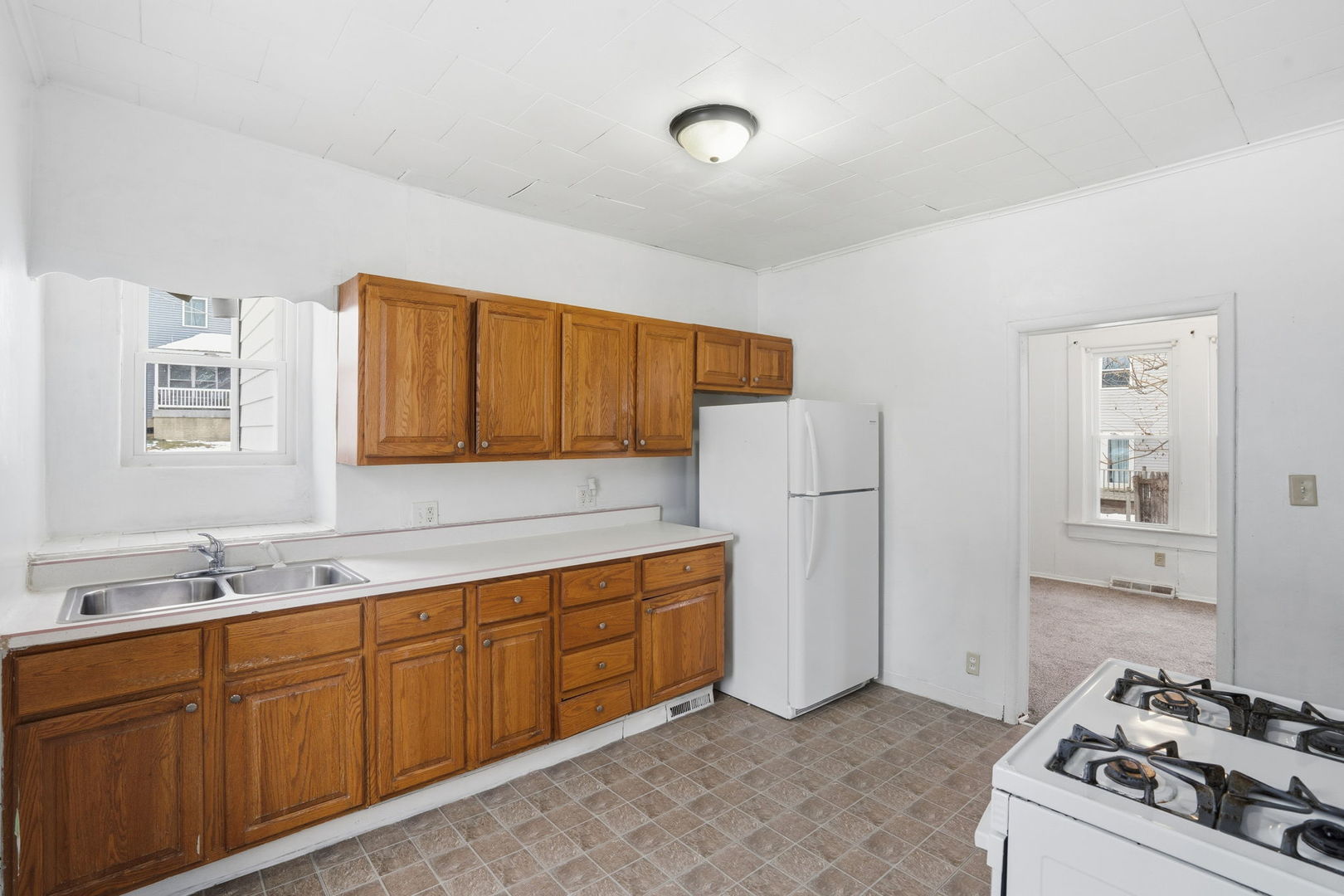 1306 17th Street Moline, IL 61265 - Photo 9 of 14 a kitchen with stainless steel appliances granite countertop a sink stove and refrigerator