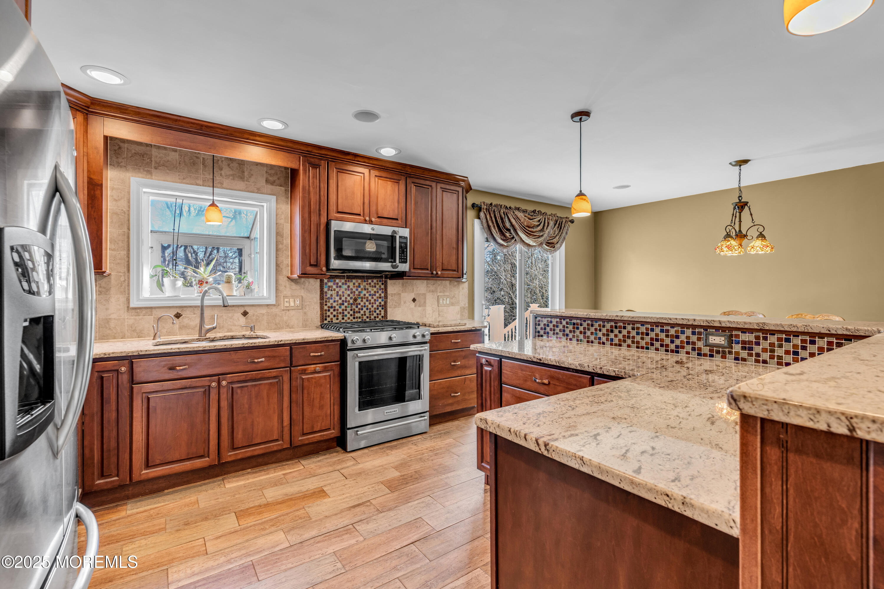12 Windsor Road Howell, NJ 07731 - Photo 11 of 56 a kitchen with stainless steel appliances granite countertop wooden floors and granite counter tops
