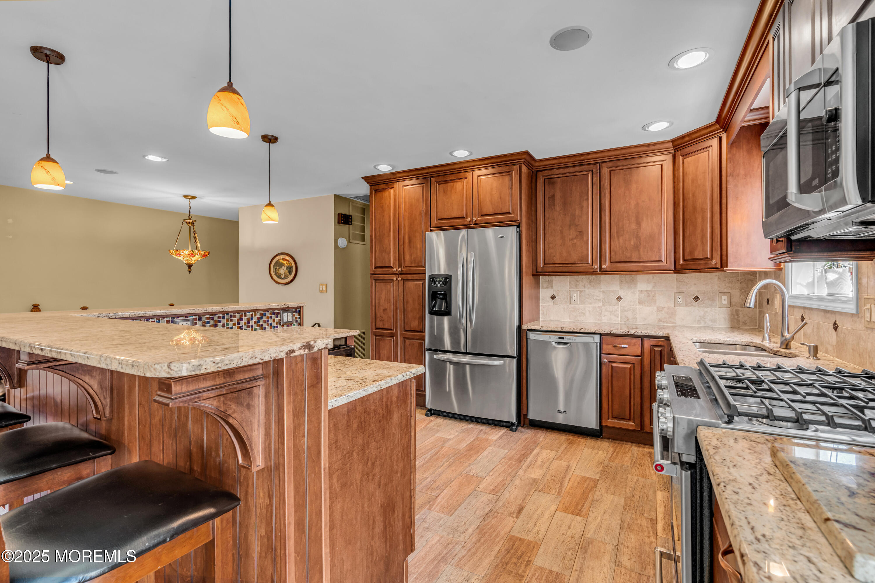 12 Windsor Road Howell, NJ 07731 - Photo 13 of 56 a kitchen with stainless steel appliances granite countertop a sink a stove and a refrigerator