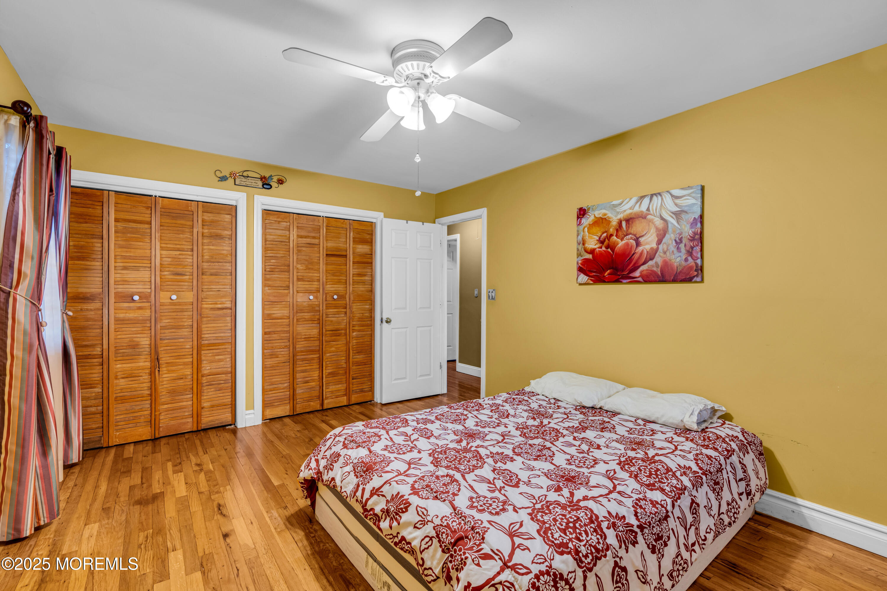 12 Windsor Road Howell, NJ 07731 - Photo 17 of 56 a bedroom with a large bed and a chandelier