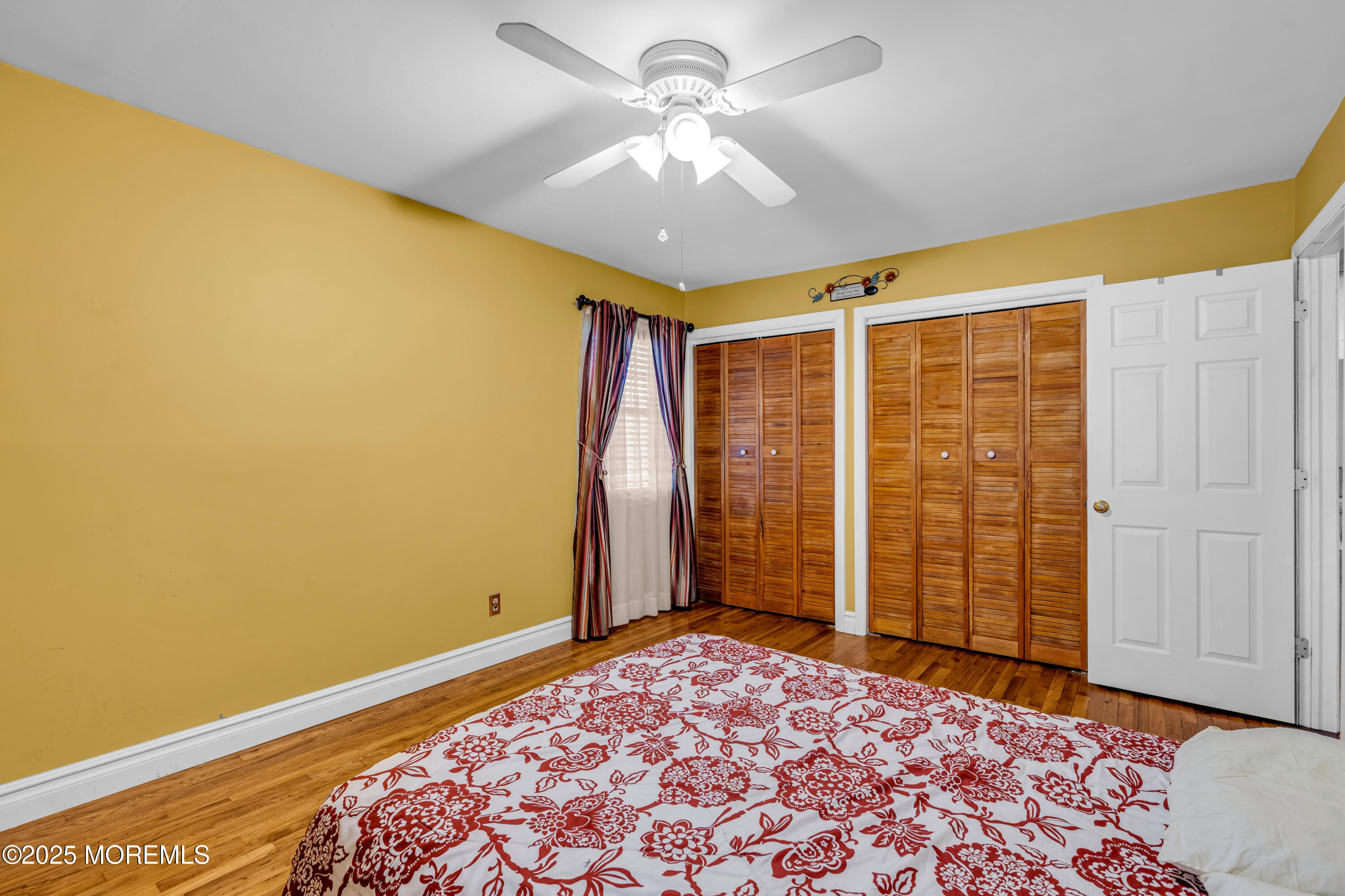 12 Windsor Road Howell, NJ 07731 - Photo 18 of 56 a view of a bedroom with a bed and a chandelier fan