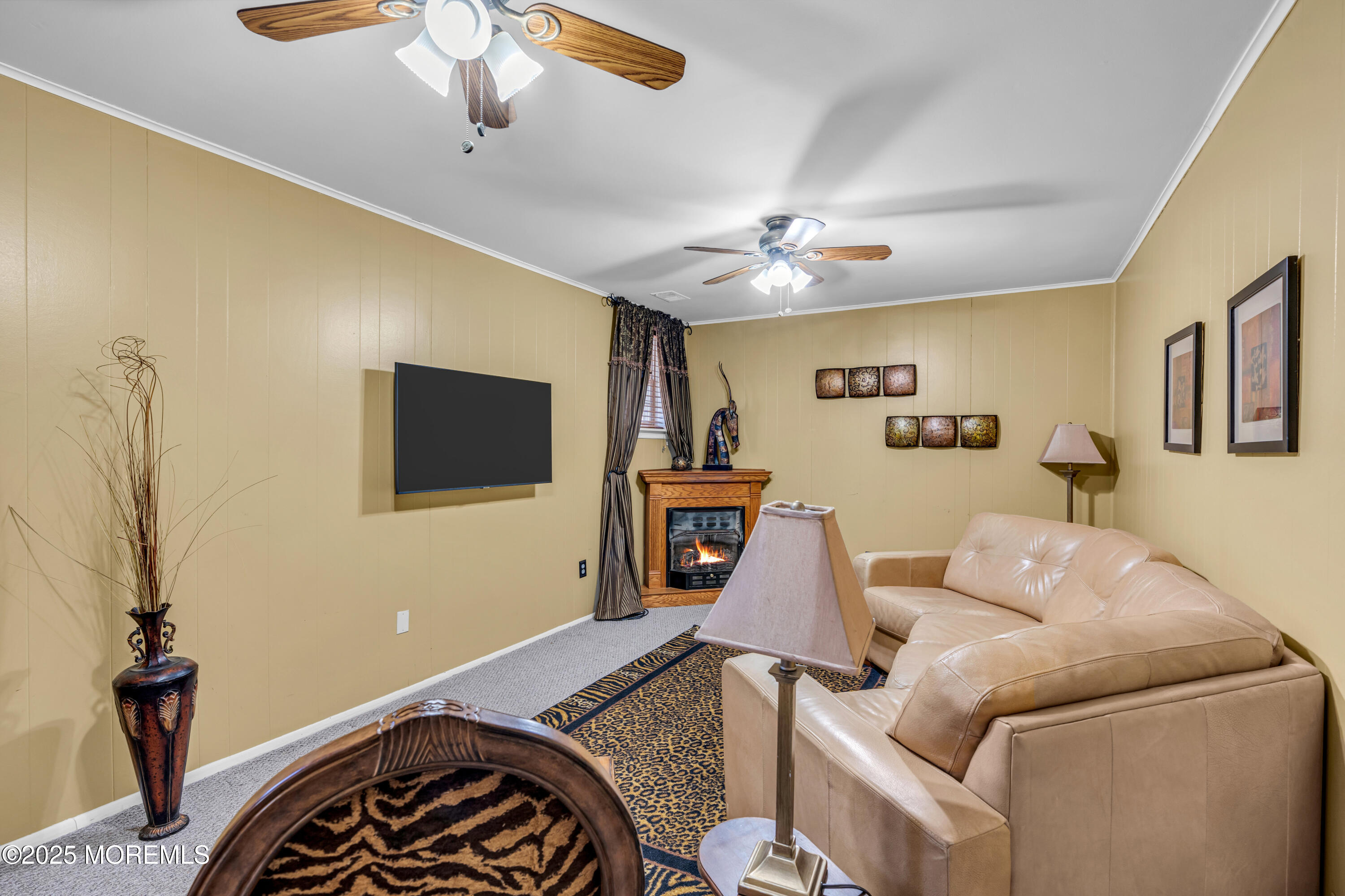 12 Windsor Road Howell, NJ 07731 - Photo 32 of 56 a living room with furniture and a flat screen tv