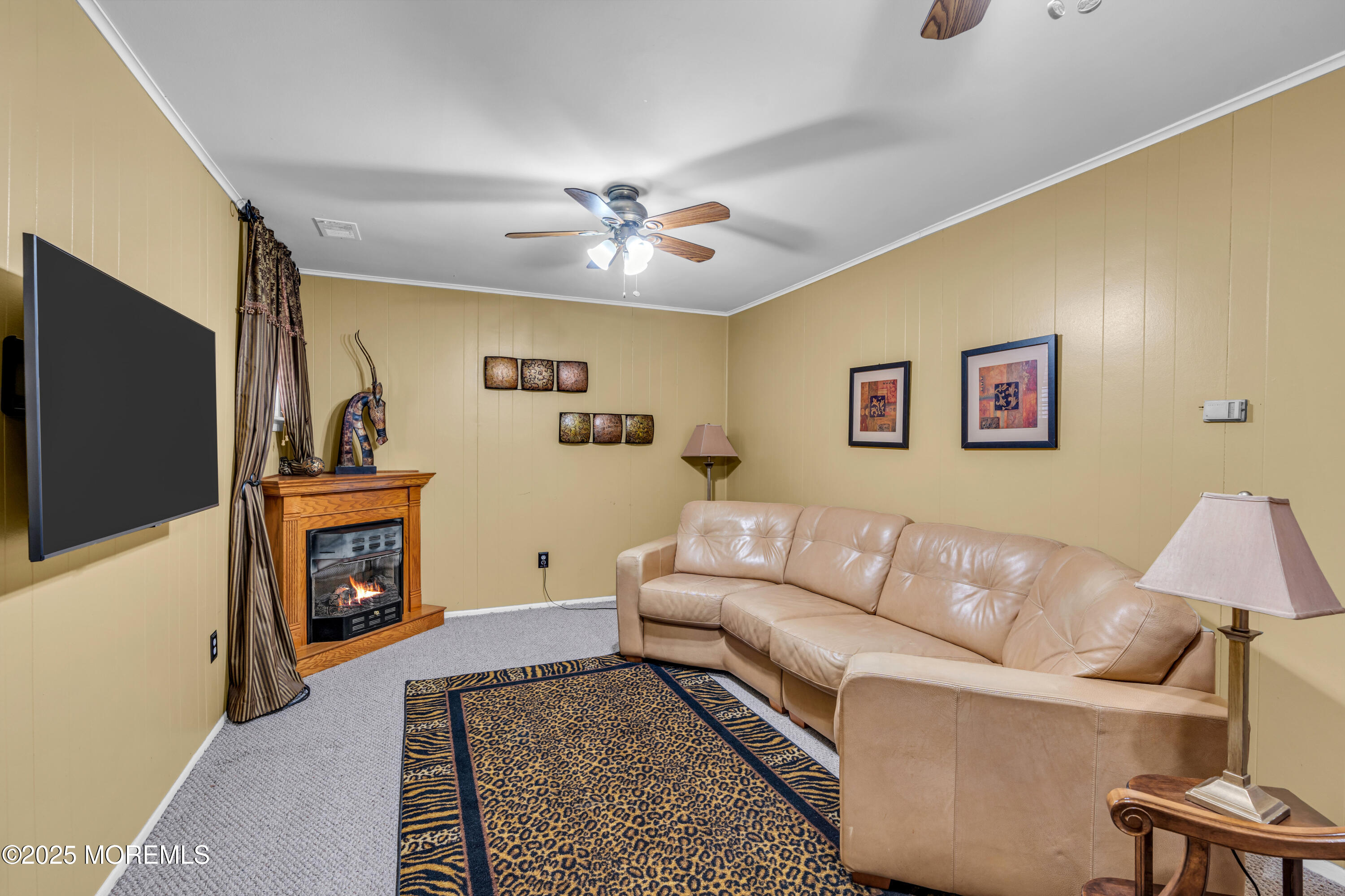 12 Windsor Road Howell, NJ 07731 - Photo 33 of 56 a living room with furniture and a flat screen tv