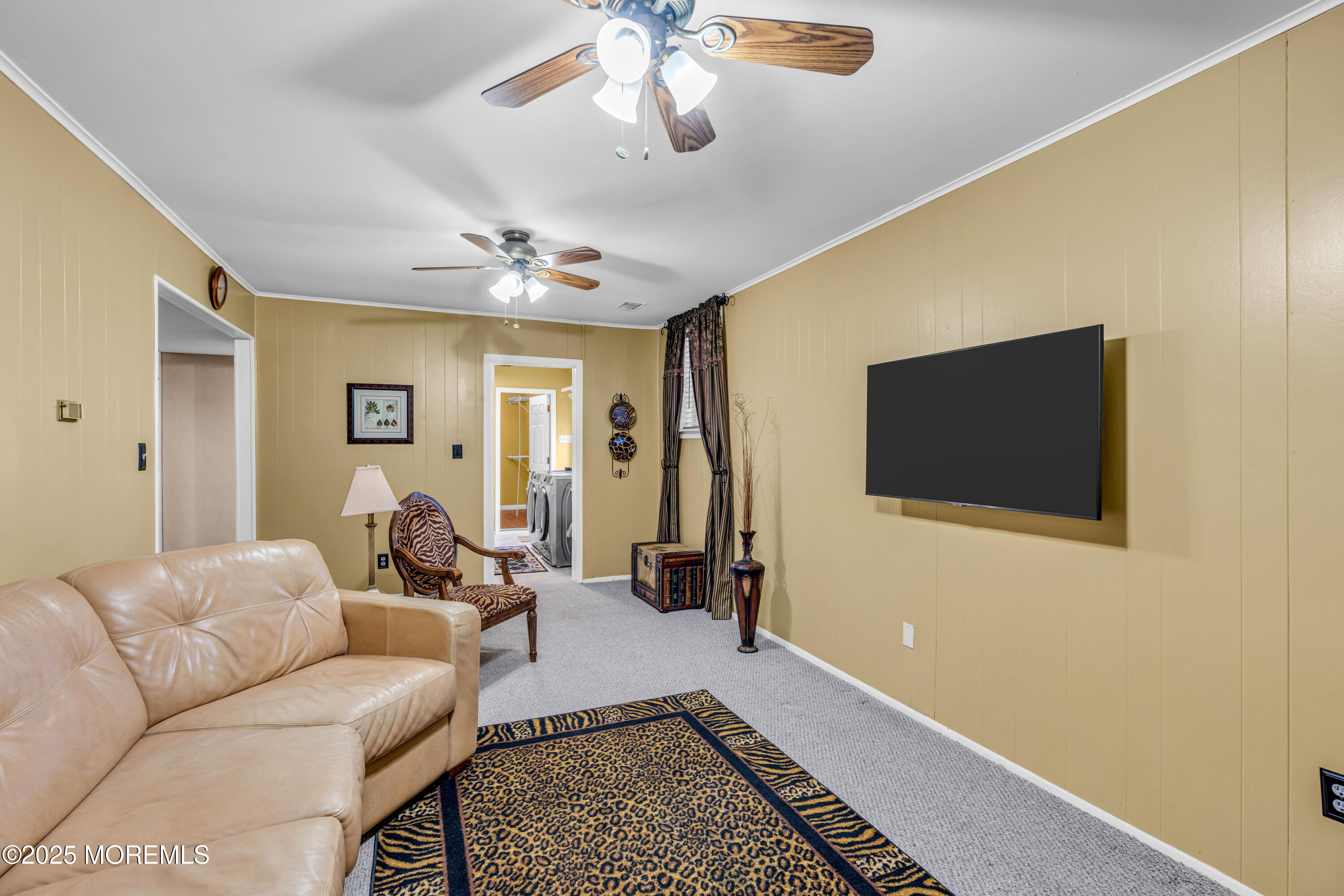 12 Windsor Road Howell, NJ 07731 - Photo 34 of 56 a living room with furniture and a flat screen tv