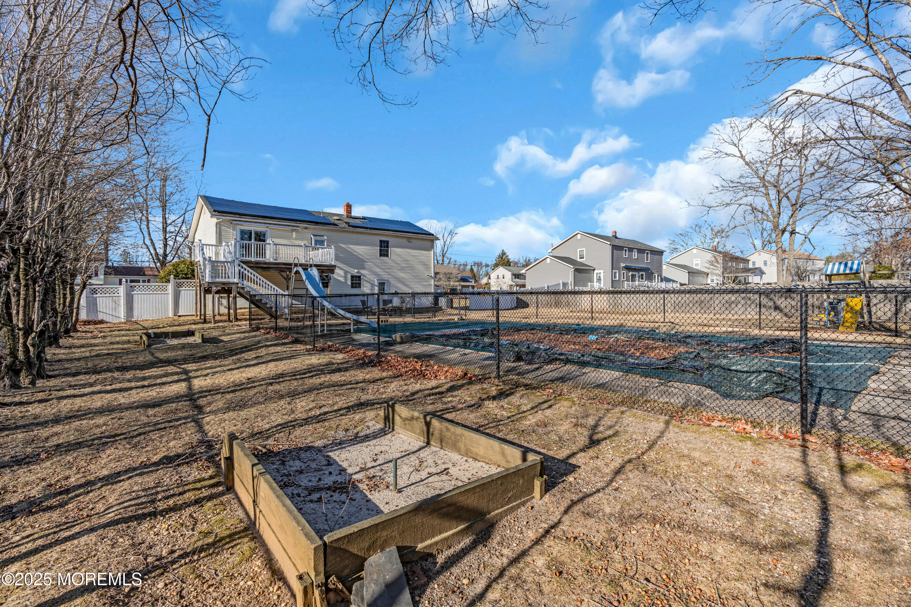 12 Windsor Road Howell, NJ 07731 - Photo 55 of 56 a view of a patio with table and chairs with wooden floor and fence