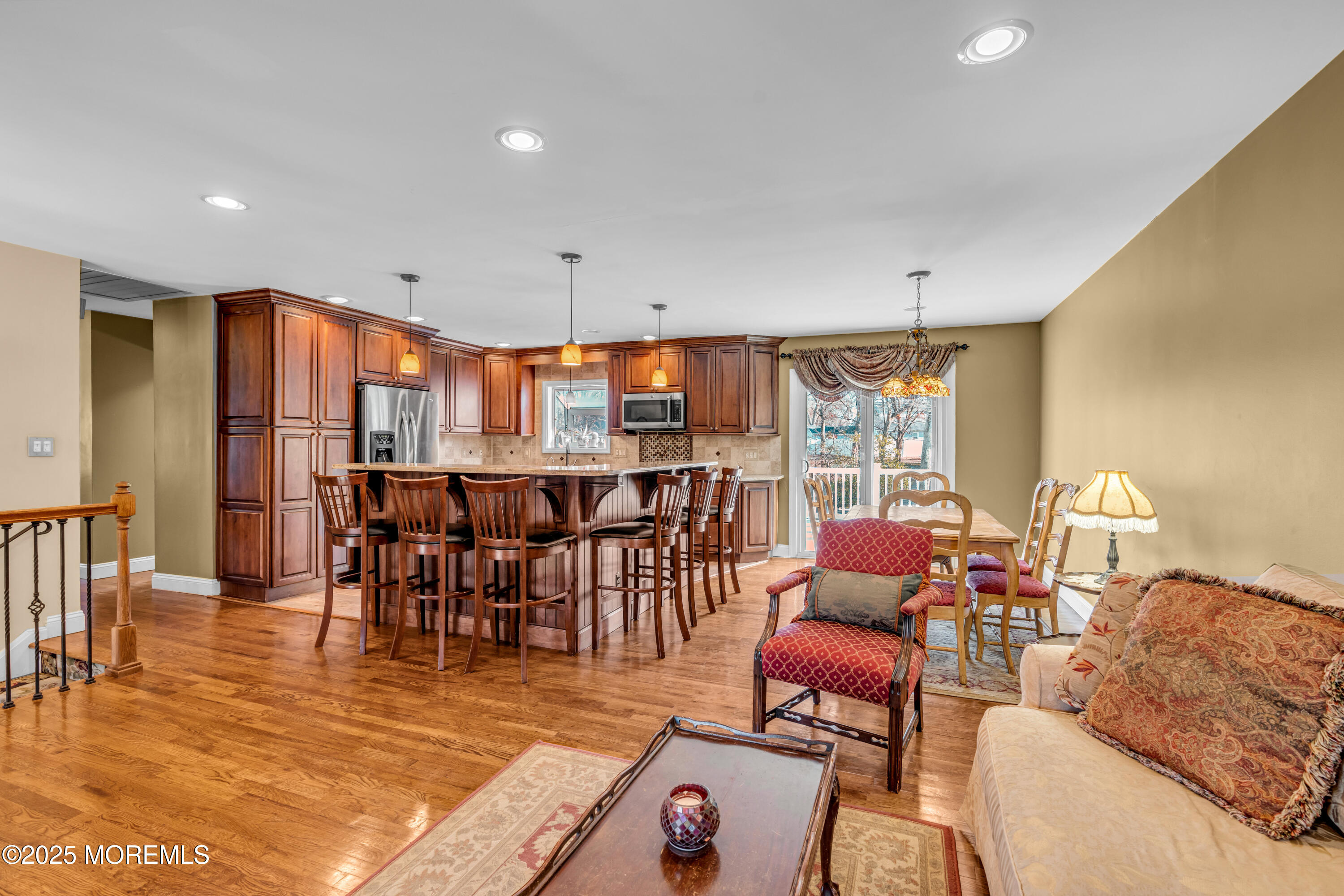 12 Windsor Road Howell, NJ 07731 - Photo 10 of 56 a living room with furniture a rug and a dining table with wooden floor