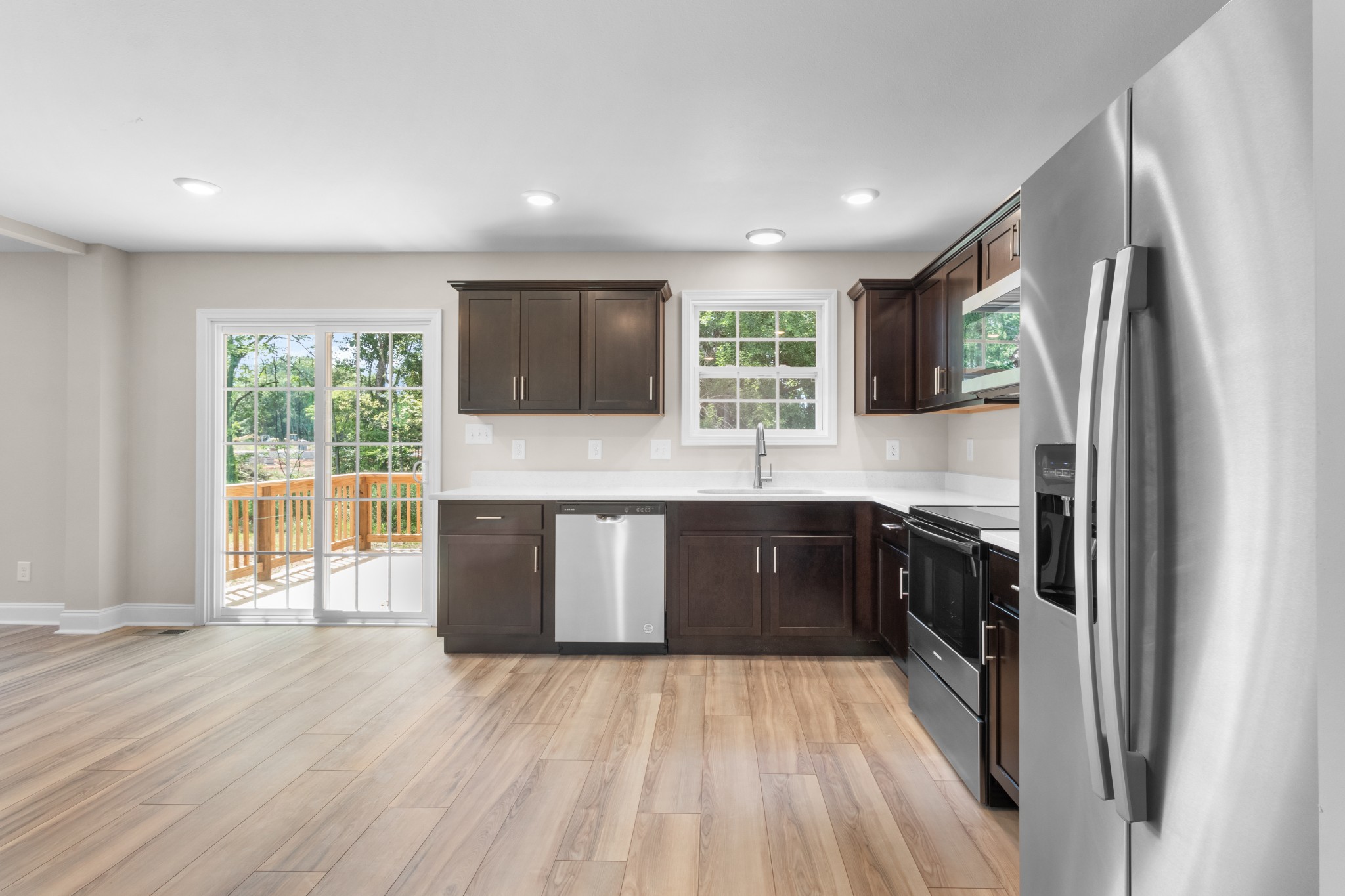 2623 Burch Road Clarksville, TN 37042 - Photo 12 of 30 a kitchen with stainless steel appliances granite countertop a refrigerator a sink dishwasher a stove and white countertops with wooden floor