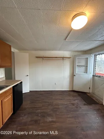 a view of a kitchen with a sink and cabinets