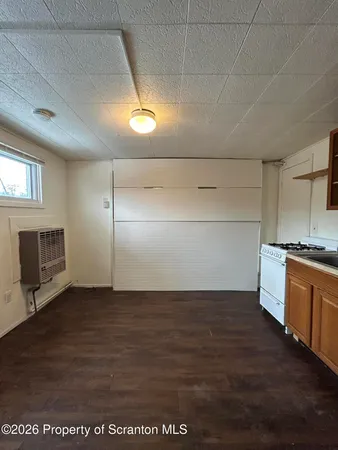 a view of a kitchen with a sink and microwave