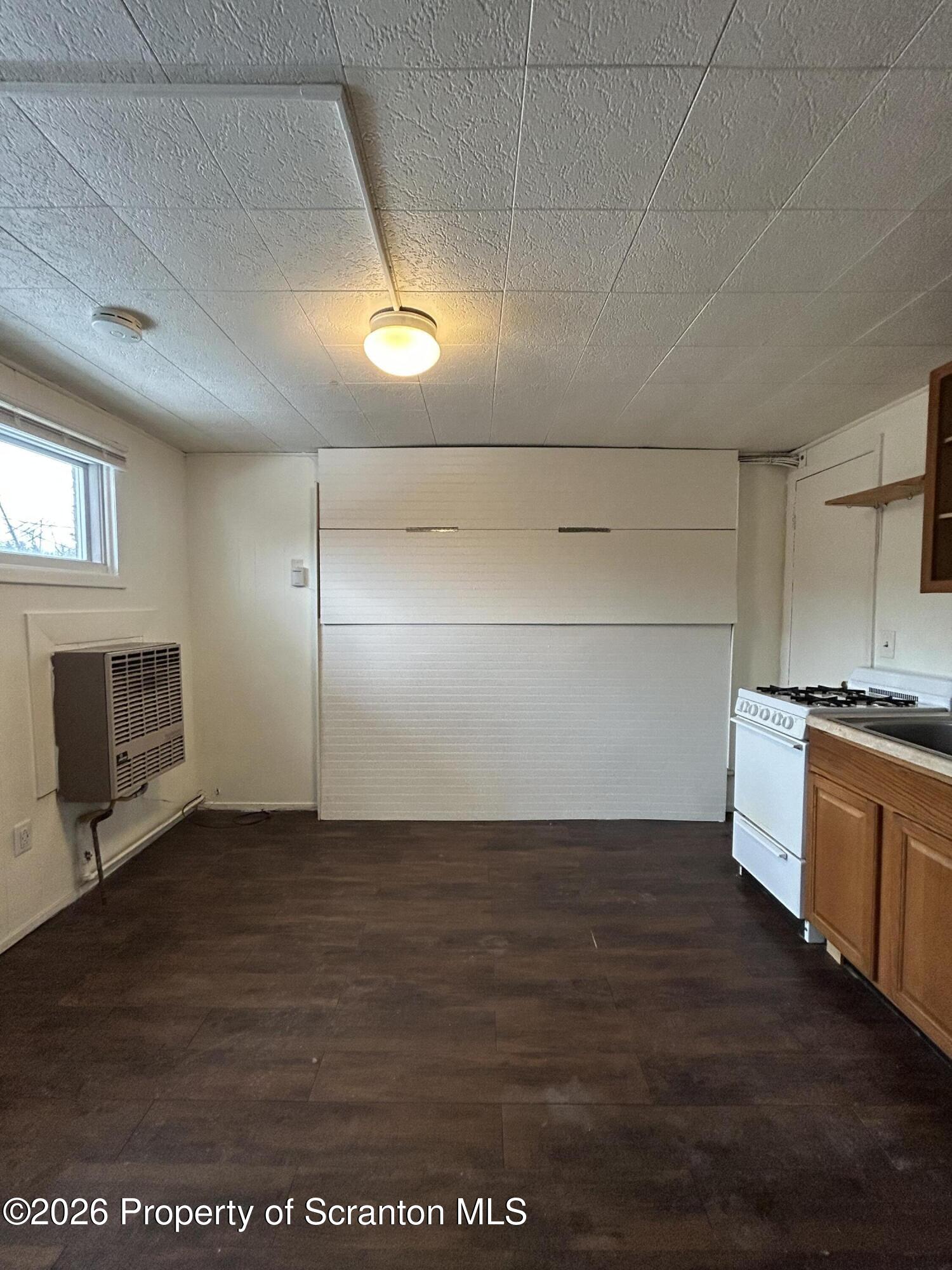 1393 1395 Old Trail Road, Unit A Clarks Summit, PA 18411 - Photo 4 of 8 a view of a kitchen with a sink and microwave