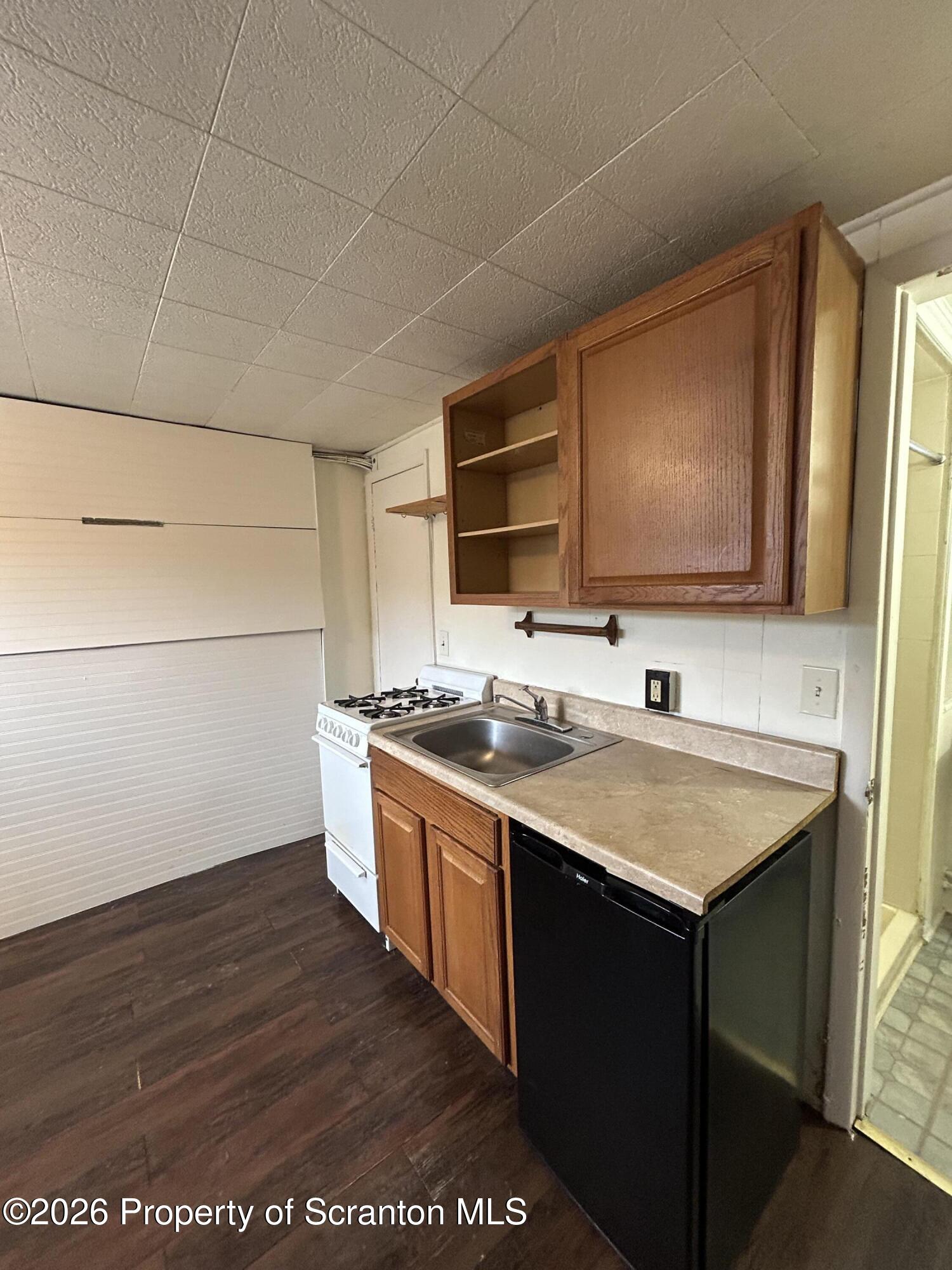 1393 1395 Old Trail Road, Unit A Clarks Summit, PA 18411 - Photo 5 of 8 a kitchen with stainless steel appliances granite countertop a sink stove and refrigerator
