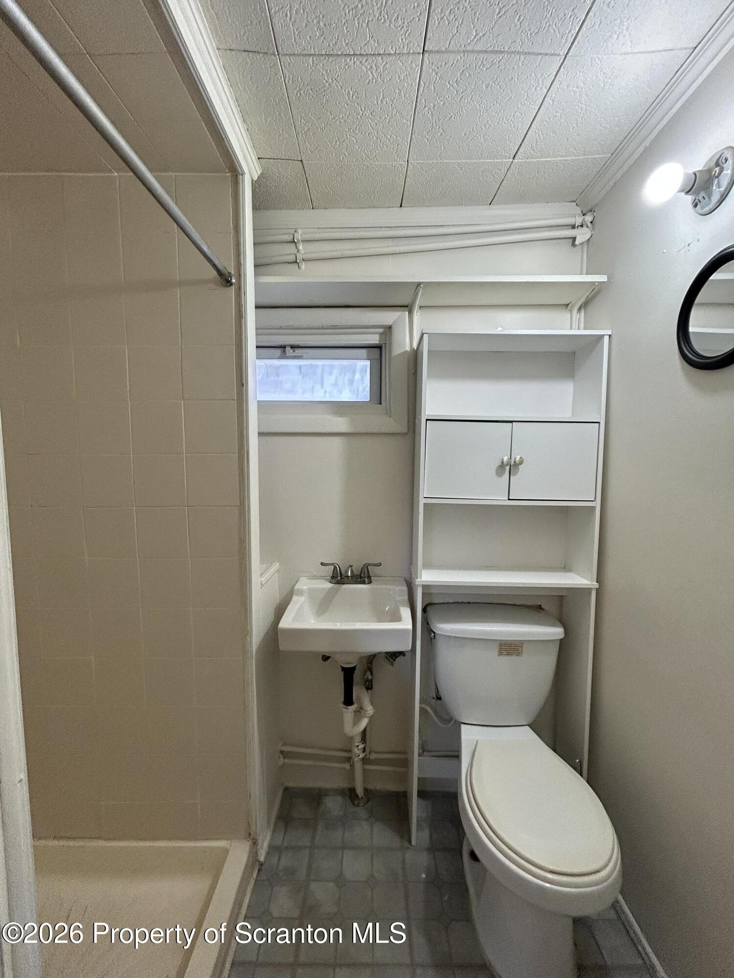 1393 1395 Old Trail Road, Unit A Clarks Summit, PA 18411 - Photo 6 of 8 a bathroom with a toilet a sink and a vanity