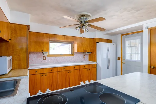a kitchen with a sink appliances and a window