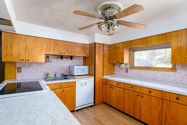 a kitchen with a sink appliances and cabinets