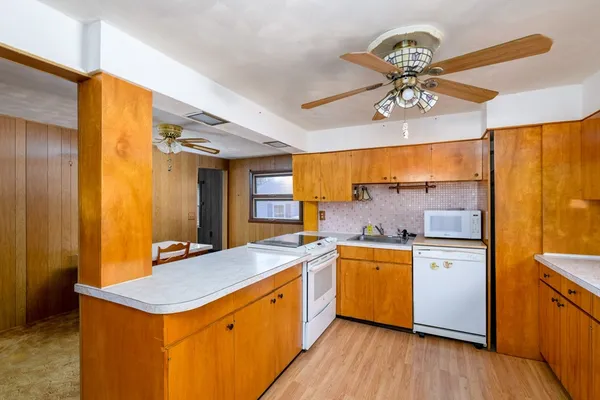 a kitchen with stainless steel appliances granite countertop cabinets wooden floor and a sink