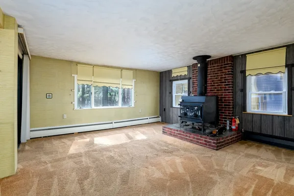 a living room with fireplace furniture and a window