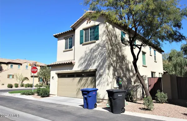 a front view of house with a garden