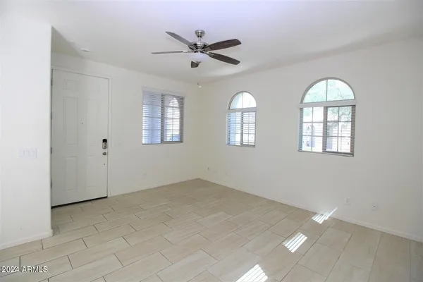 an empty room with windows and closet