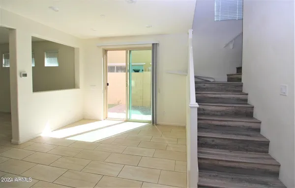 a view of an entryway with wooden floor and a bathroom