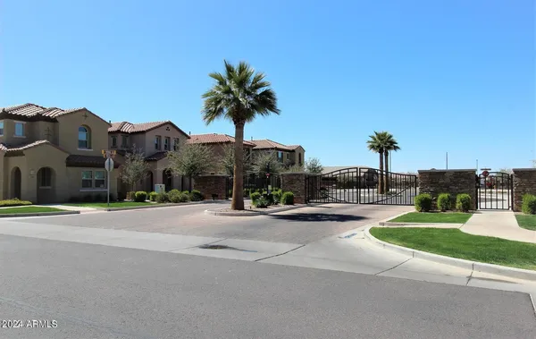 a front view of multiple house with yard and green space
