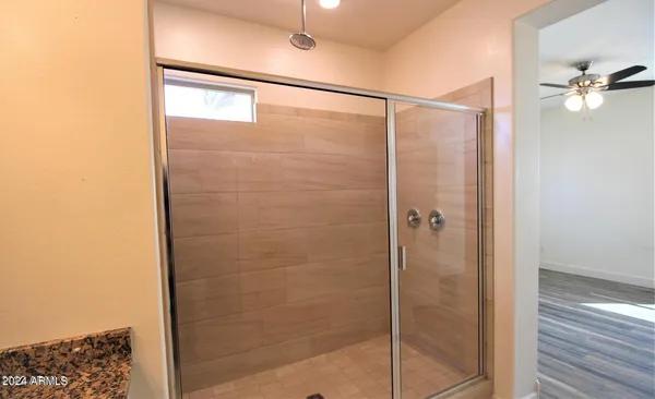 a bathroom with a glass shower door