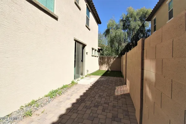 a path view of a house with a backyard