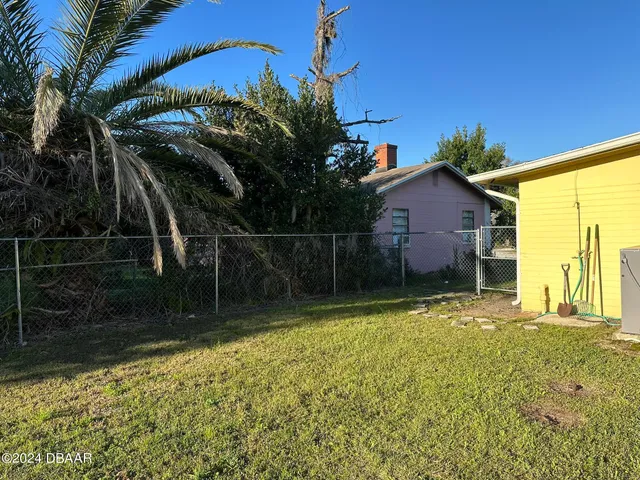 a backyard of a house with lots of green space