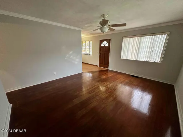 wooden floor in an empty room with a window