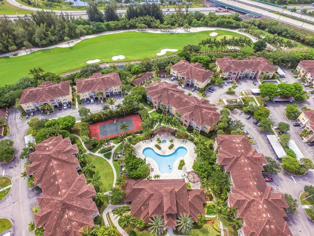 an aerial view of lake and residential houses with outdoor space