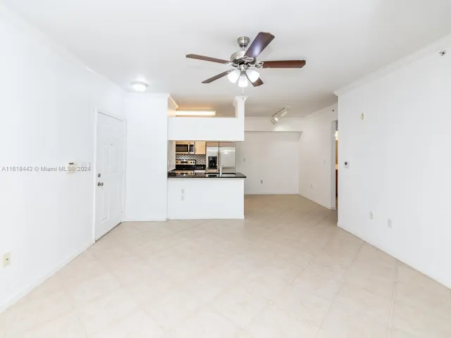 a view of a kitchen with a sink and a refrigerator