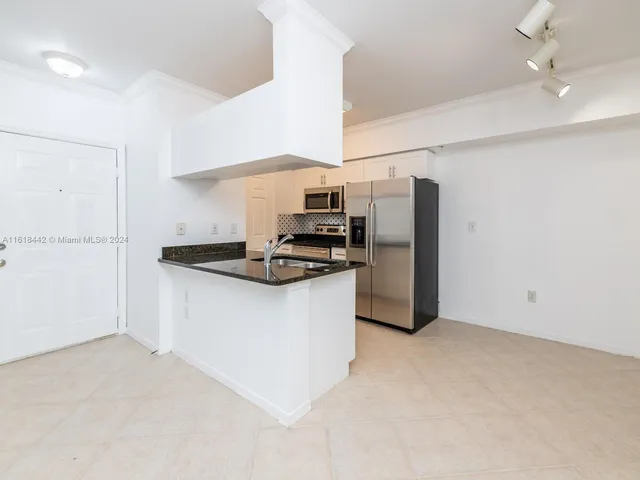 a kitchen with stainless steel appliances a refrigerator and a stove