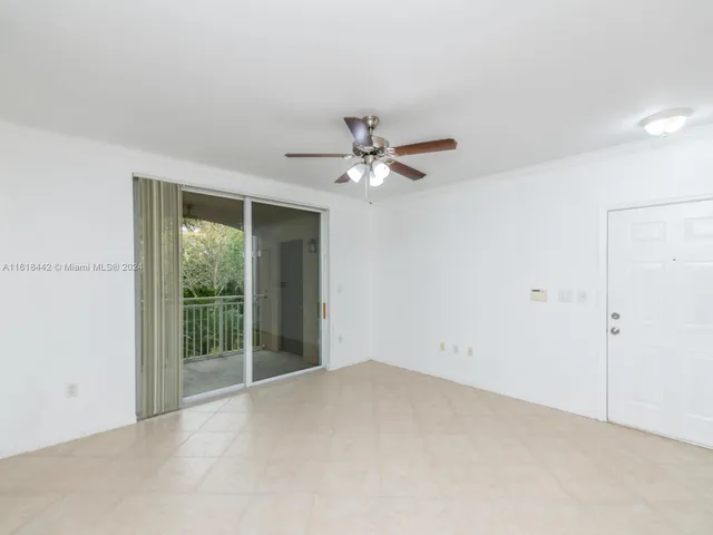 a view of an empty room with a ceiling fan