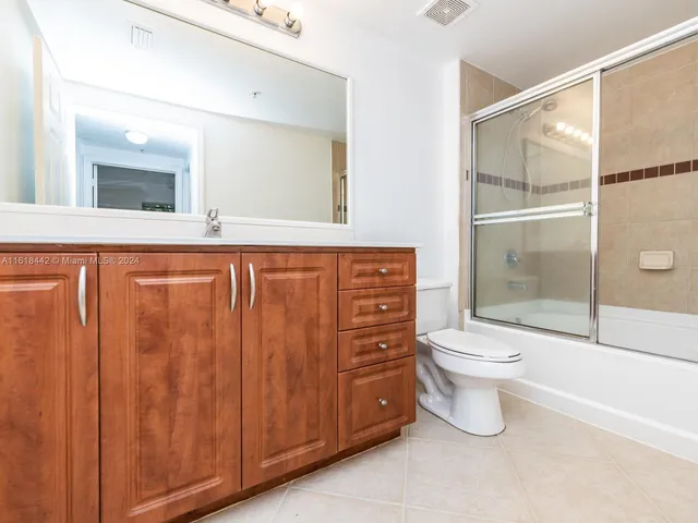 a bathroom with a toilet a sink and shower