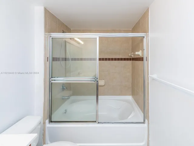 a bathroom with a glass shower door