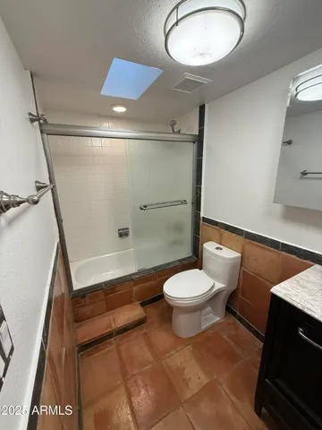 a bathroom with a toilet a sink and shower