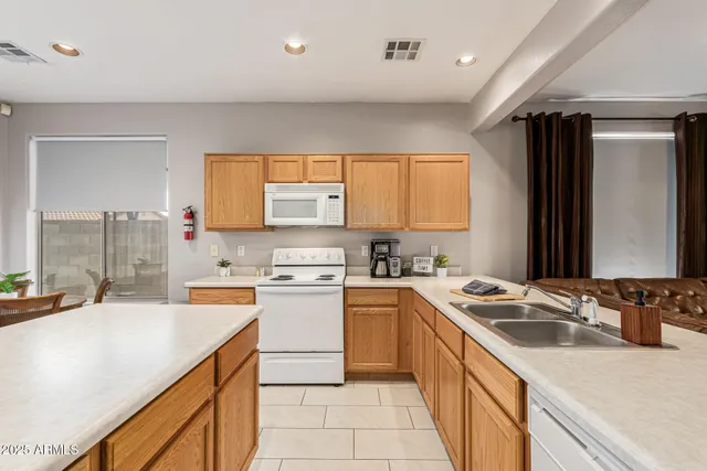 a kitchen with a sink stove and cabinets