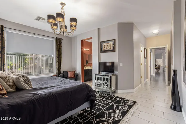 a bedroom with a bed and a chandelier