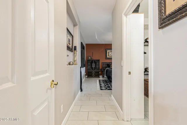 a view of a hallway with closet and cars