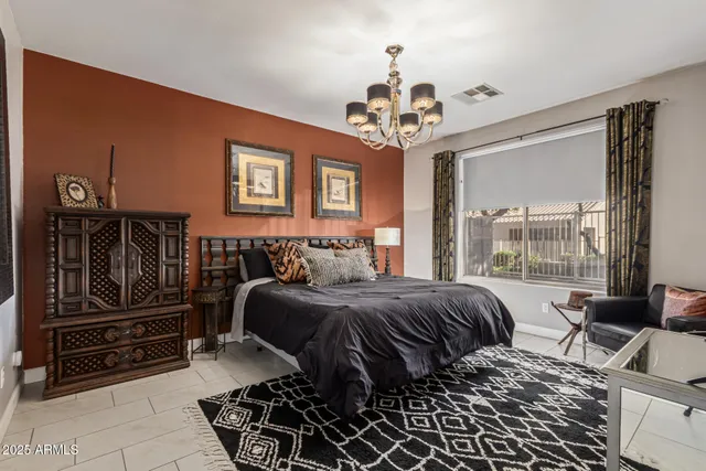 a bed room with a bed and a chandelier