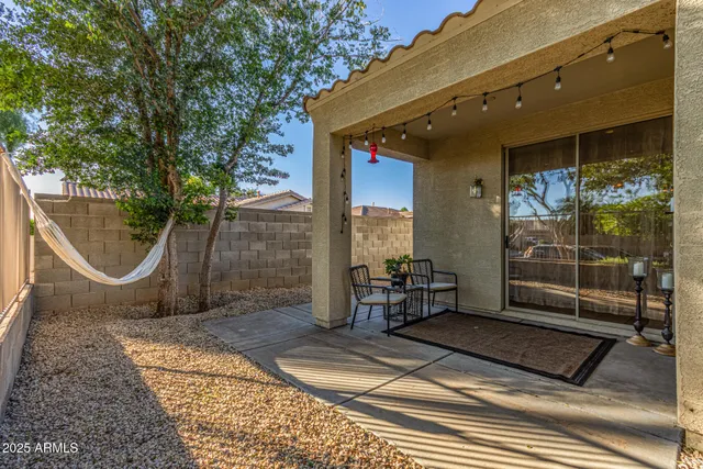 a view of a house with swimming pool and sitting area