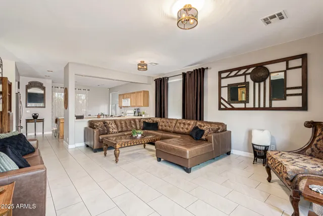 a living room with furniture and a dining table