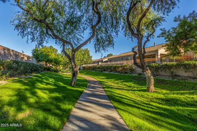 a view of a garden with sitting area
