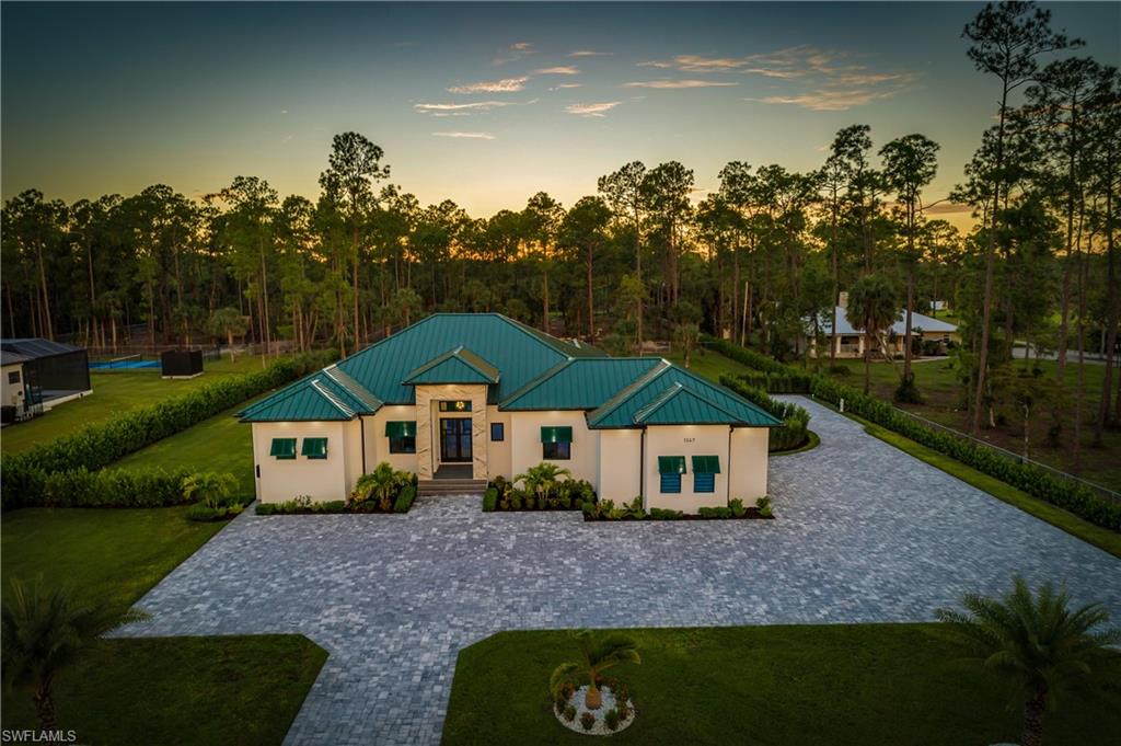 1347 23rd Street Southwest Naples, FL 34117 - Photo 1 of 50 a house with trees in the background
