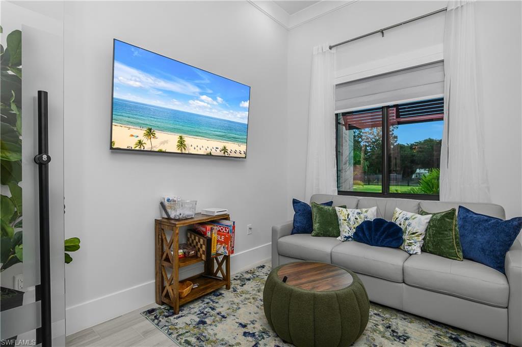 1347 23rd Street Southwest Naples, FL 34117 - Photo 12 of 50 a living room with furniture and a gate