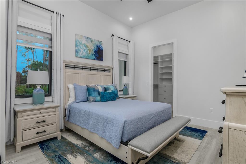 1347 23rd Street Southwest Naples, FL 34117 - Photo 16 of 50 a bedroom with a bed and a dresser