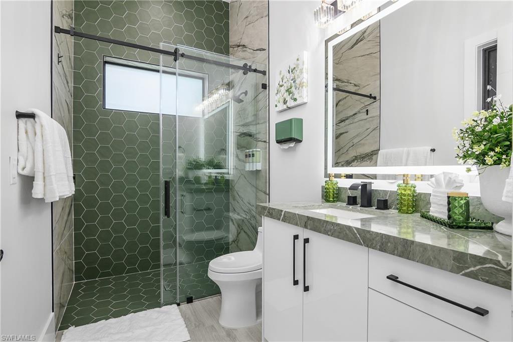 1347 23rd Street Southwest Naples, FL 34117 - Photo 19 of 50 a bathroom with a sink a toilet and shower