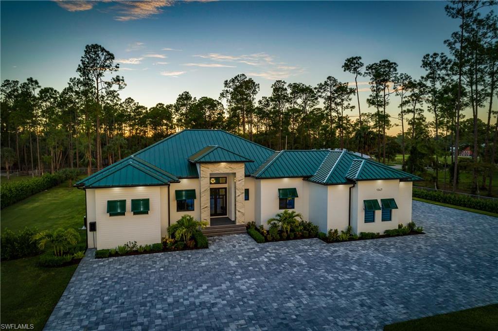 1347 23rd Street Southwest Naples, FL 34117 - Photo 2 of 50 a view of a house with a yard